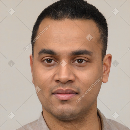 Joyful latino young-adult male with short  black hair and brown eyes