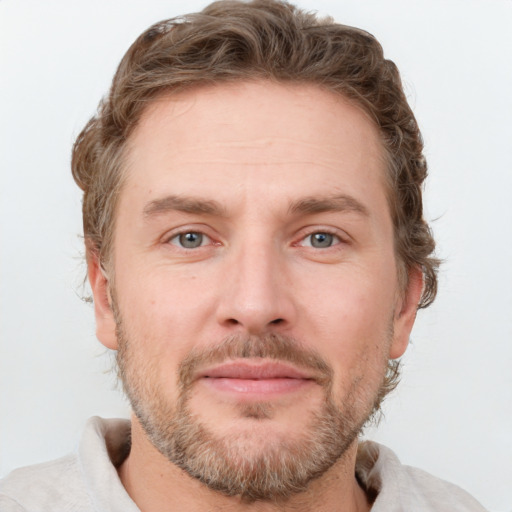 Joyful white adult male with short  brown hair and grey eyes