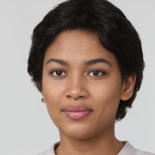 Joyful latino young-adult female with short  brown hair and brown eyes