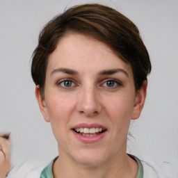 Joyful white young-adult female with short  brown hair and grey eyes