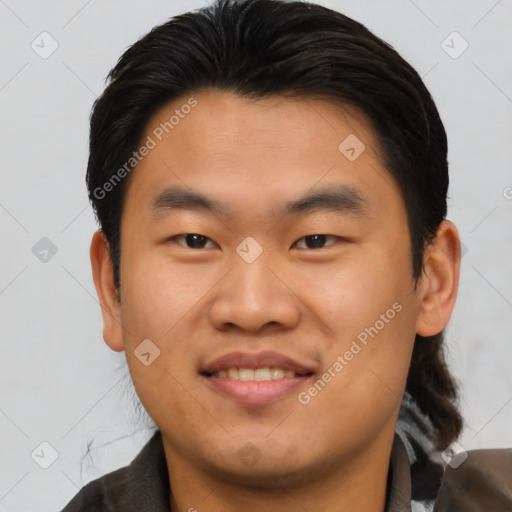 Joyful asian young-adult male with short  brown hair and brown eyes