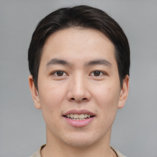 Joyful asian young-adult male with short  brown hair and brown eyes