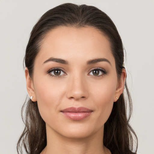 Joyful white young-adult female with long  brown hair and brown eyes