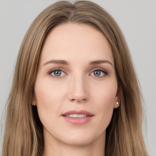 Joyful white young-adult female with long  brown hair and grey eyes