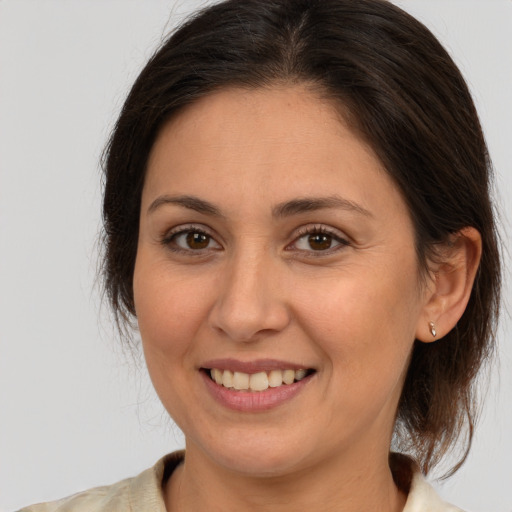 Joyful white adult female with medium  brown hair and brown eyes