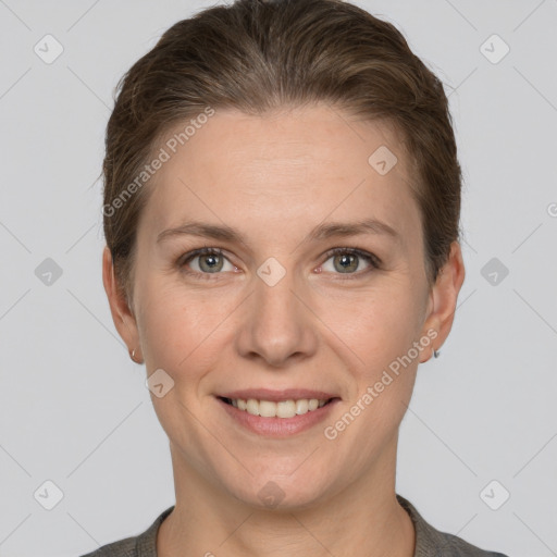 Joyful white adult female with short  brown hair and grey eyes