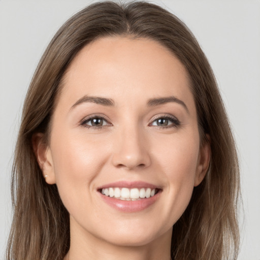 Joyful white young-adult female with long  brown hair and brown eyes