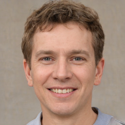 Joyful white adult male with short  brown hair and grey eyes