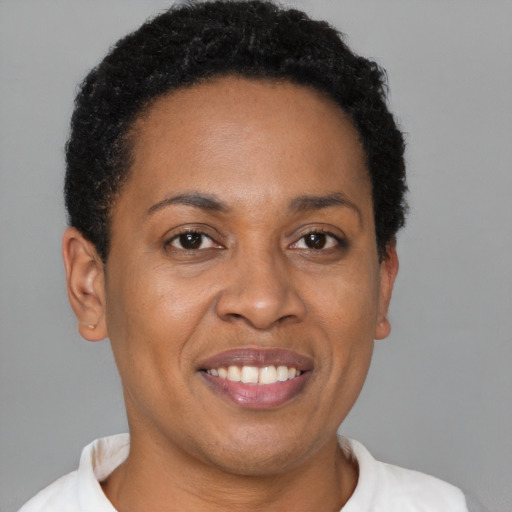Joyful black young-adult female with short  brown hair and brown eyes