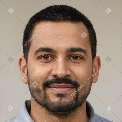 Joyful latino young-adult male with short  black hair and brown eyes