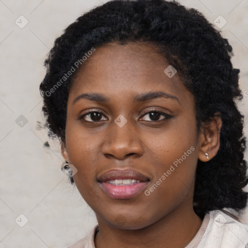 Joyful black young-adult female with long  black hair and brown eyes