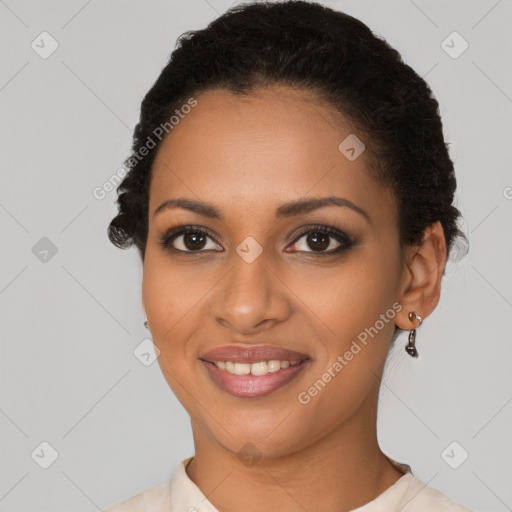 Joyful black young-adult female with short  black hair and brown eyes