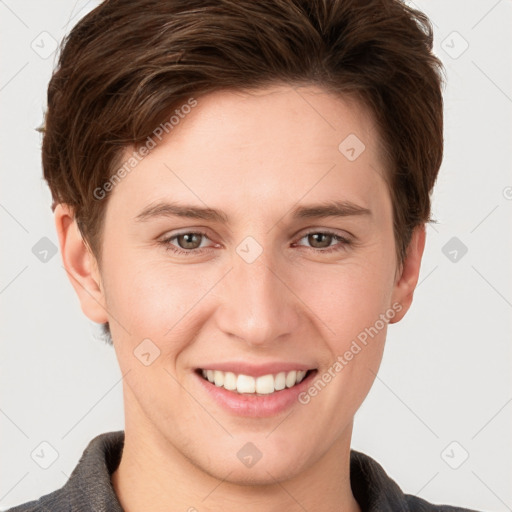 Joyful white young-adult female with short  brown hair and grey eyes