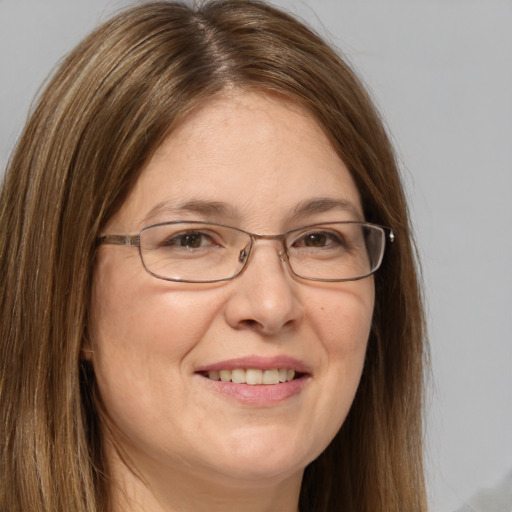 Joyful white adult female with long  brown hair and brown eyes