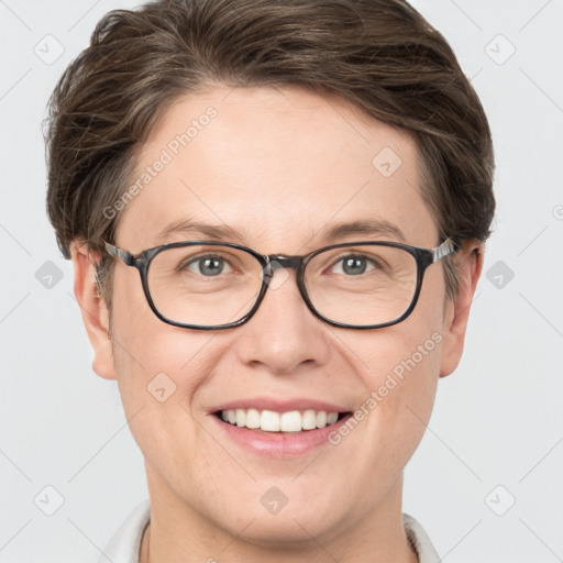 Joyful white young-adult female with short  brown hair and grey eyes