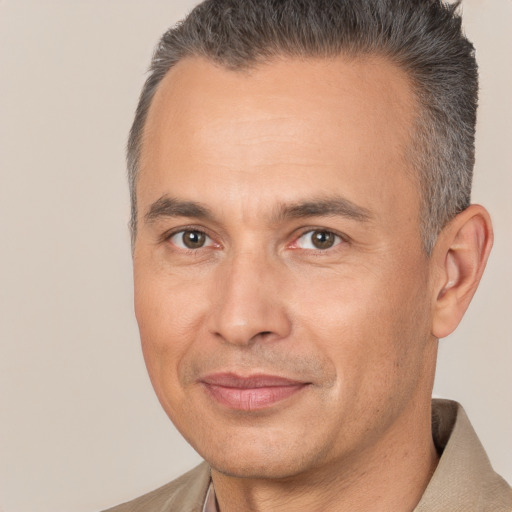 Joyful white adult male with short  brown hair and brown eyes