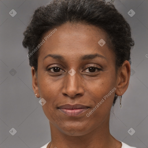 Joyful black adult female with short  brown hair and brown eyes