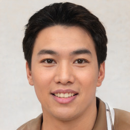 Joyful asian young-adult male with short  black hair and brown eyes