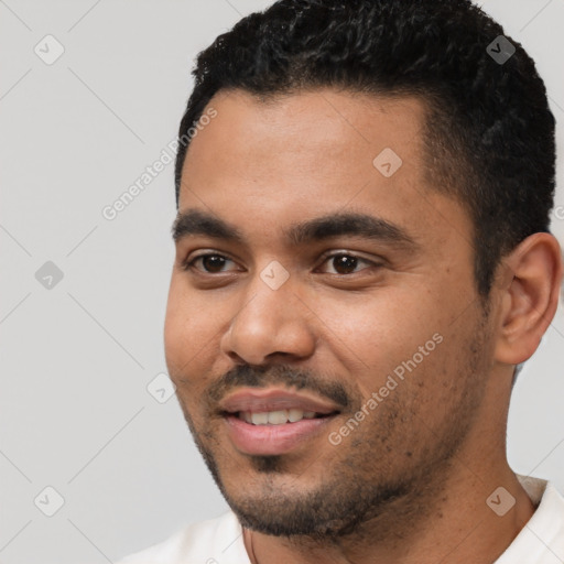 Joyful latino young-adult male with short  black hair and brown eyes