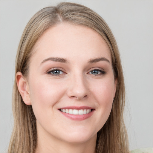 Joyful white young-adult female with long  brown hair and grey eyes