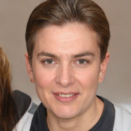 Joyful white adult male with medium  brown hair and brown eyes