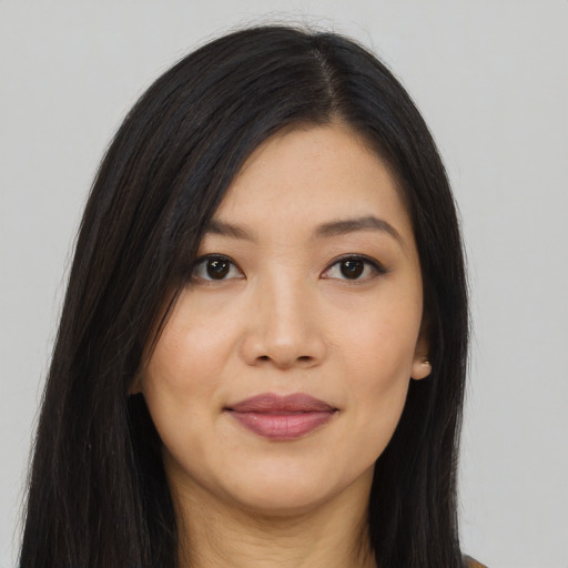 Joyful asian young-adult female with long  black hair and brown eyes