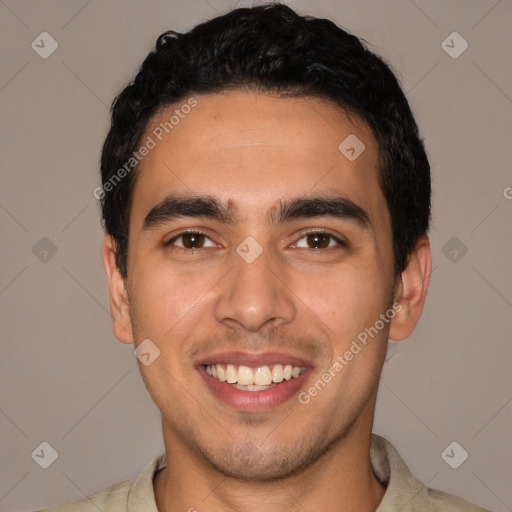 Joyful latino young-adult male with short  black hair and brown eyes