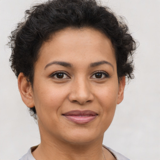 Joyful latino young-adult female with short  brown hair and brown eyes