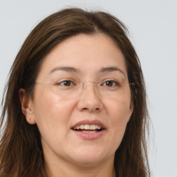 Joyful white adult female with long  brown hair and grey eyes