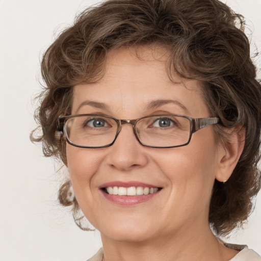 Joyful white adult female with medium  brown hair and blue eyes