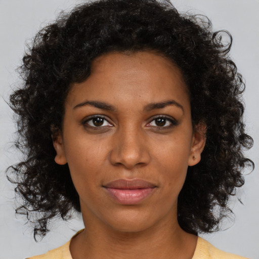 Neutral black young-adult female with medium  brown hair and brown eyes