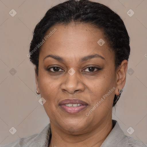 Joyful black adult female with short  brown hair and brown eyes