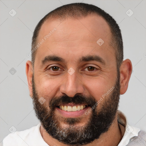 Joyful white adult male with short  black hair and brown eyes