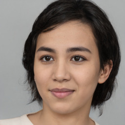 Joyful asian young-adult female with medium  black hair and brown eyes