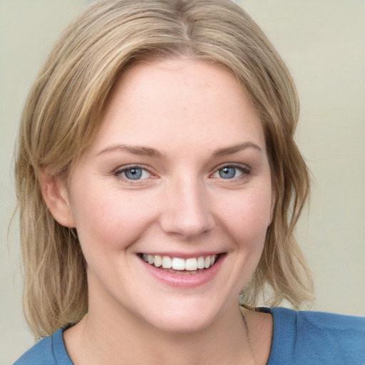 Joyful white young-adult female with medium  brown hair and blue eyes