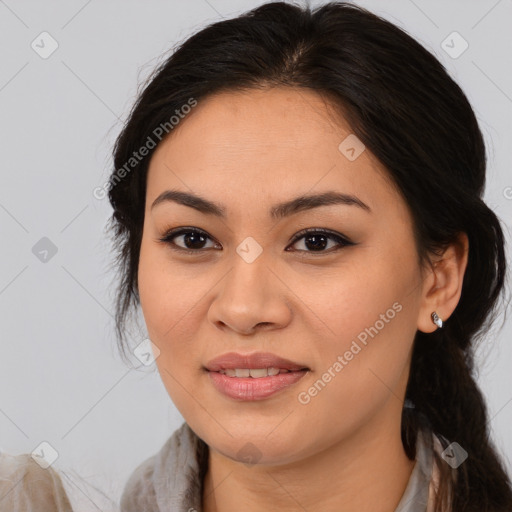 Joyful latino young-adult female with medium  brown hair and brown eyes