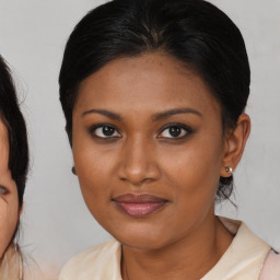 Joyful black young-adult female with medium  brown hair and brown eyes