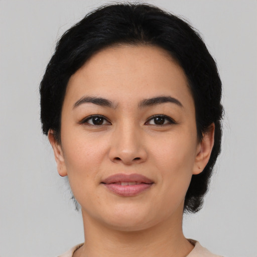 Joyful asian young-adult female with medium  black hair and brown eyes