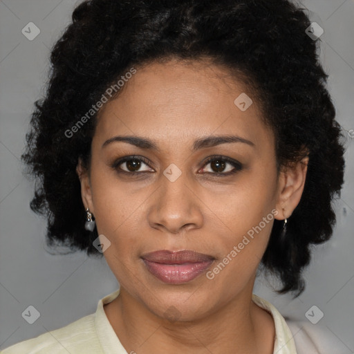 Joyful black adult female with medium  brown hair and brown eyes