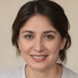 Joyful white adult female with medium  brown hair and brown eyes