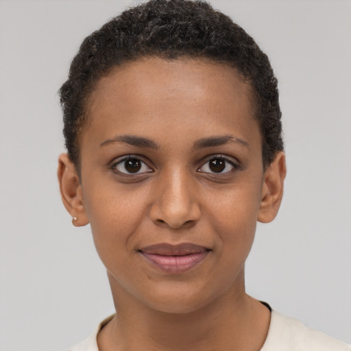 Joyful black young-adult female with short  brown hair and brown eyes