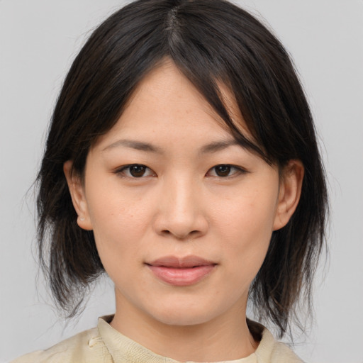 Joyful asian young-adult female with medium  brown hair and brown eyes