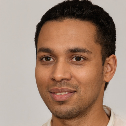 Joyful black young-adult male with short  black hair and brown eyes