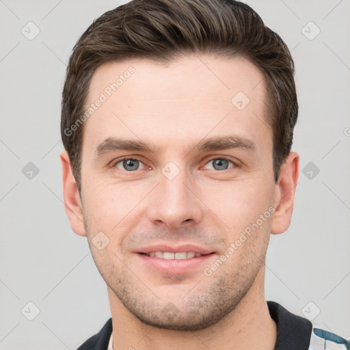 Joyful white young-adult male with short  brown hair and grey eyes