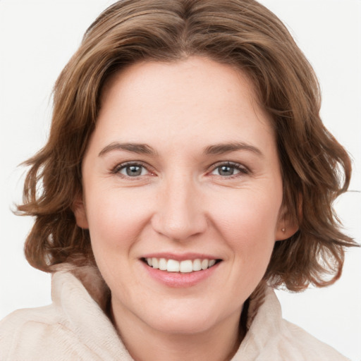 Joyful white young-adult female with medium  brown hair and green eyes