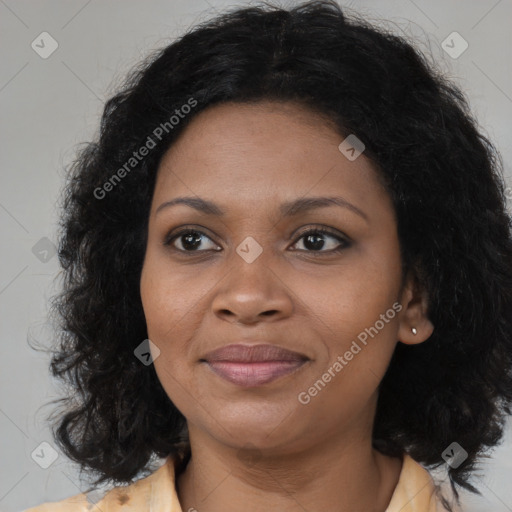 Joyful black adult female with medium  brown hair and brown eyes