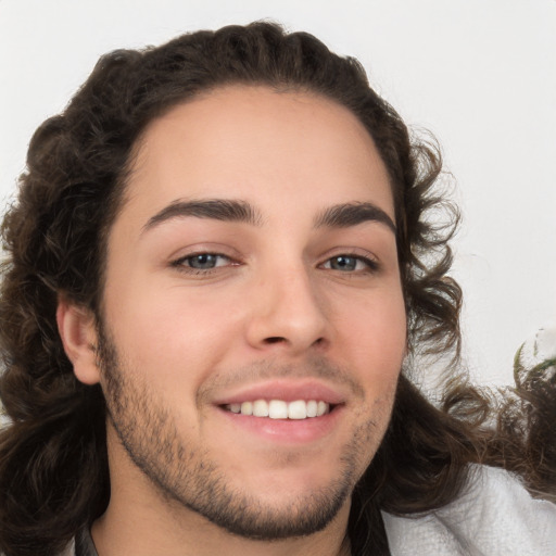 Joyful white young-adult male with medium  brown hair and brown eyes