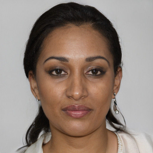 Joyful black young-adult female with medium  black hair and brown eyes