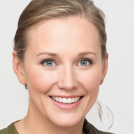 Joyful white young-adult female with medium  brown hair and blue eyes