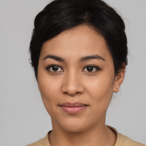Joyful asian young-adult female with short  black hair and brown eyes